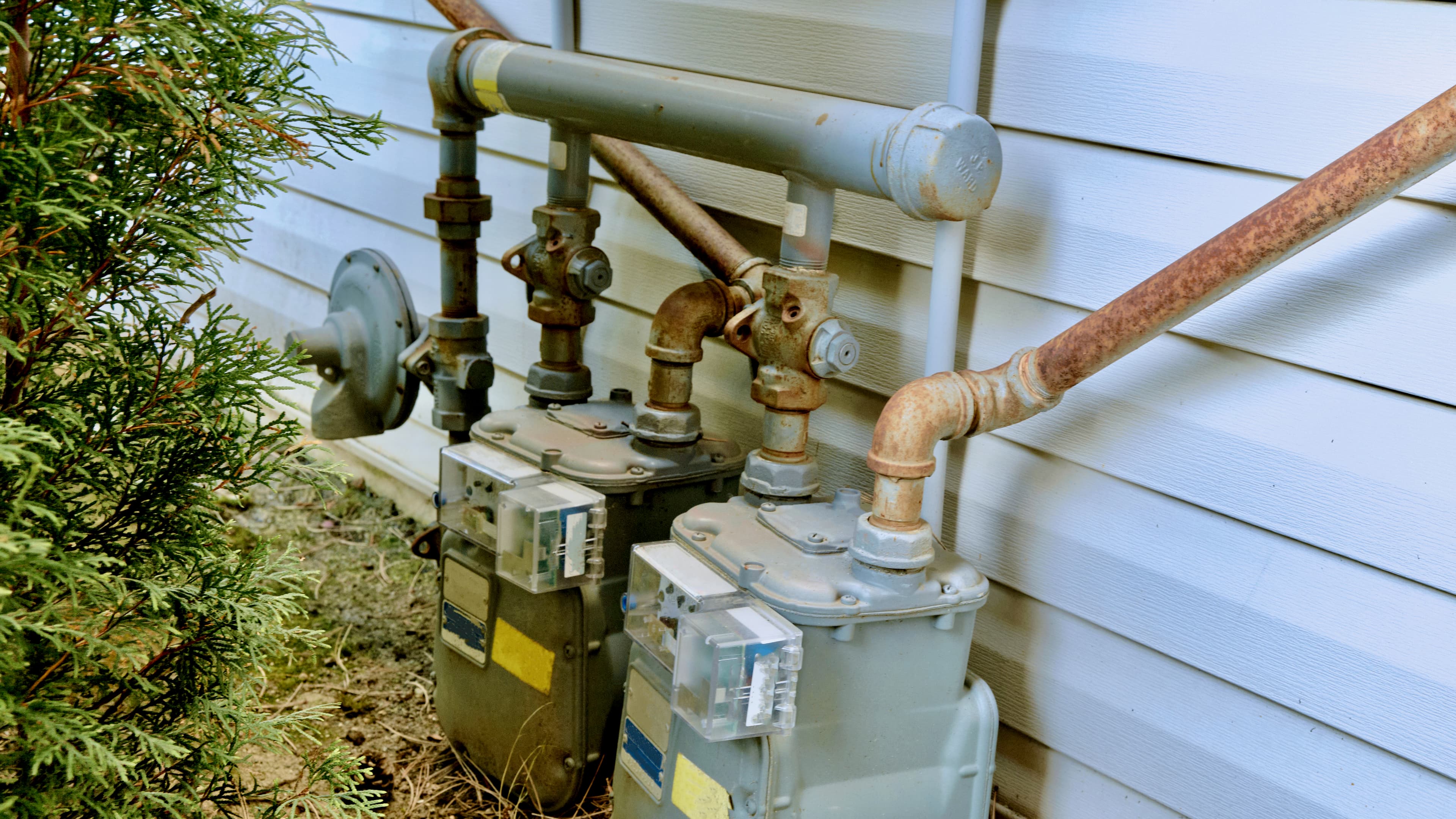 Natural gas service line attached to the side of a building